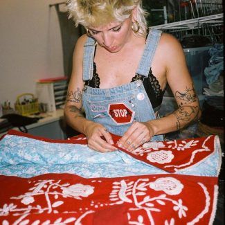 alt= photo artist woman with embroidered jacket