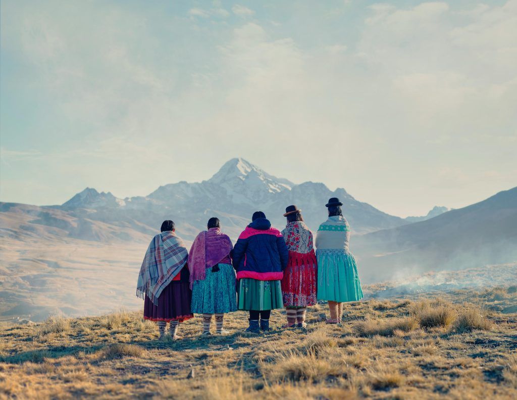 alt= Cholitas-escaladoras_ observing the mountains_Le Gist_Todd Antony
